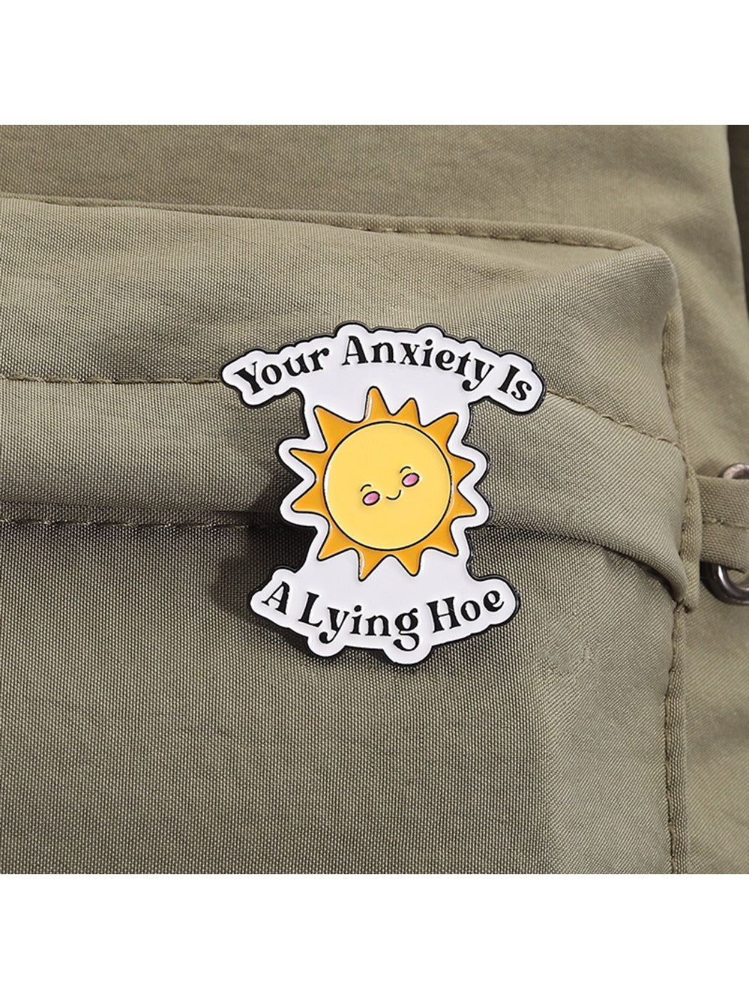 Side view of Pinori cartoon sun brooch highlighting metal clasp and enamel finish