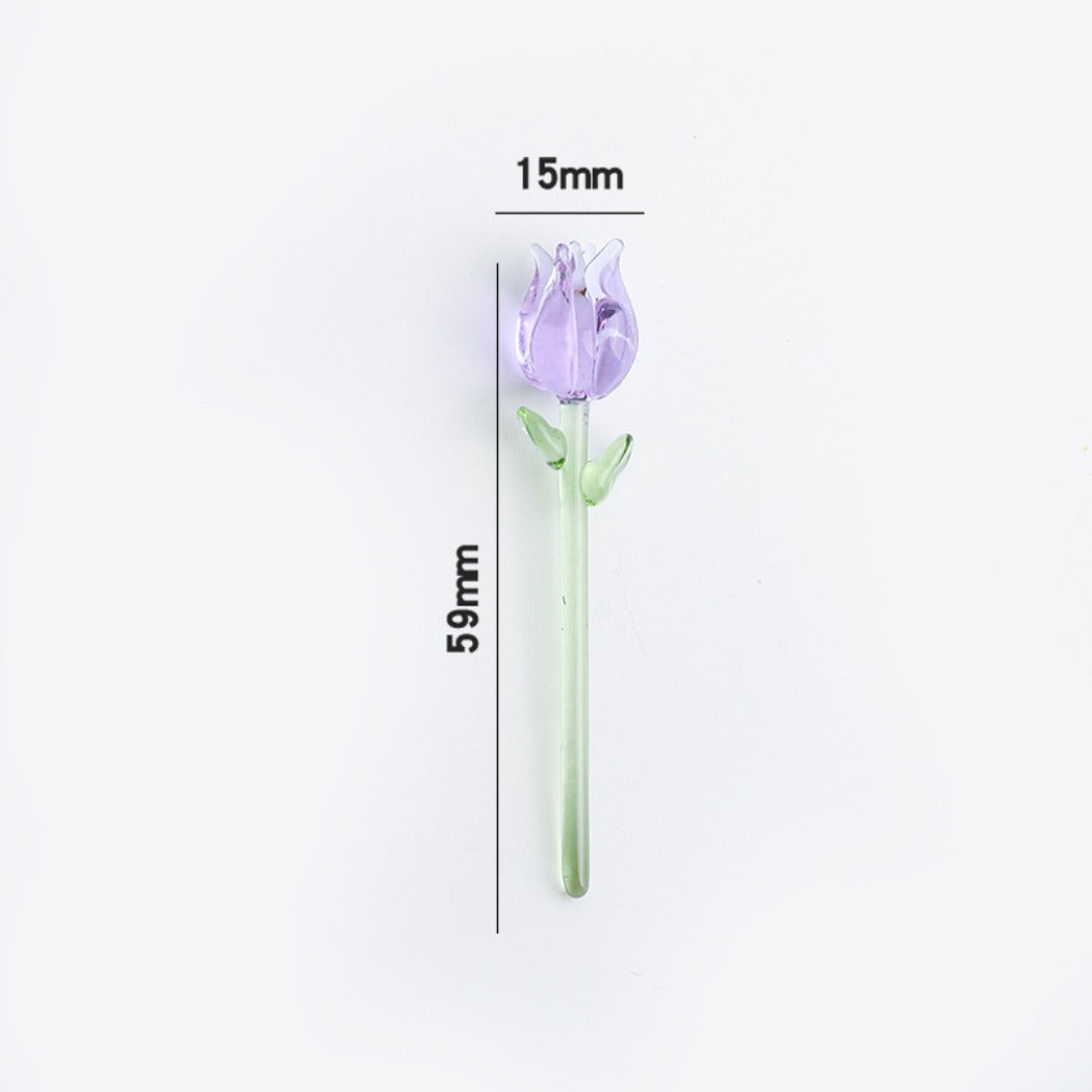 Miniature glass rose held between fingers showing its compact size and detail