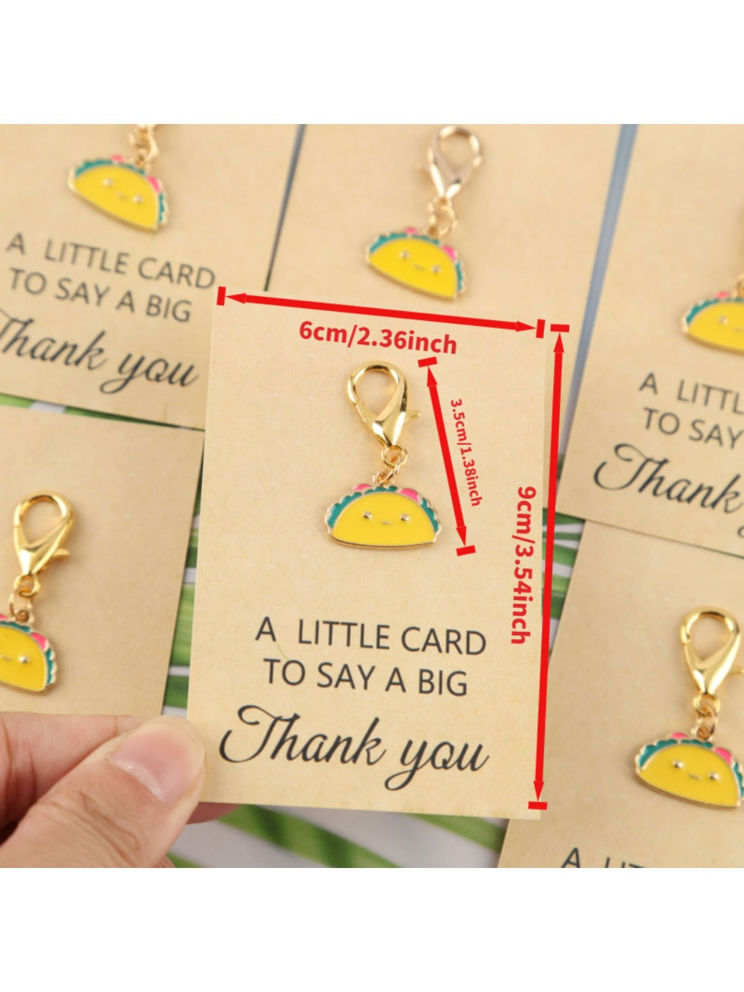 Multiple taco keychains and greeting cards spread out on a flat surface