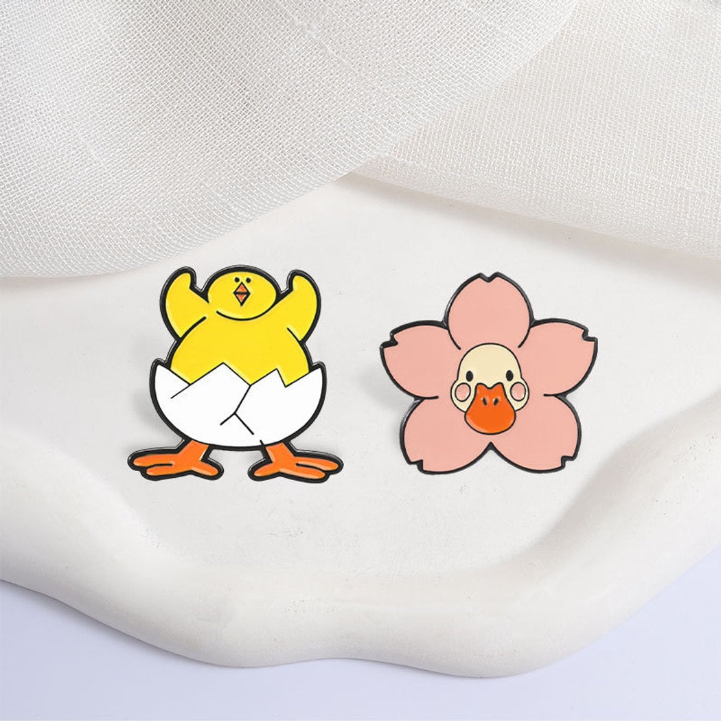 Pinori - Playful Duck and Flower Motif Pin