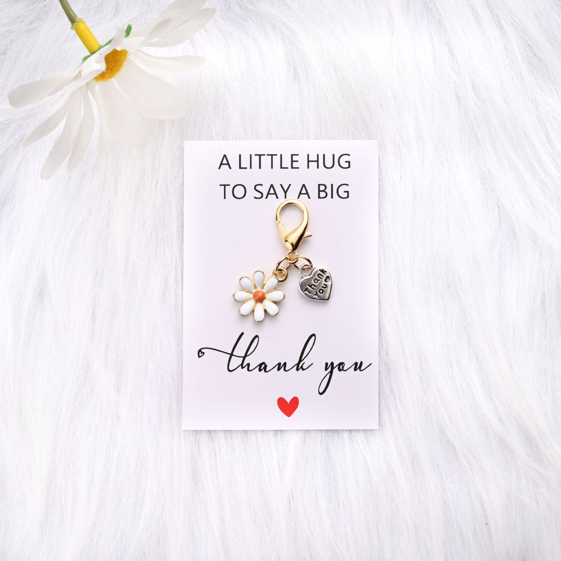 Hand holding Taphug Daisy Heart Thank You Pocket Hug card
