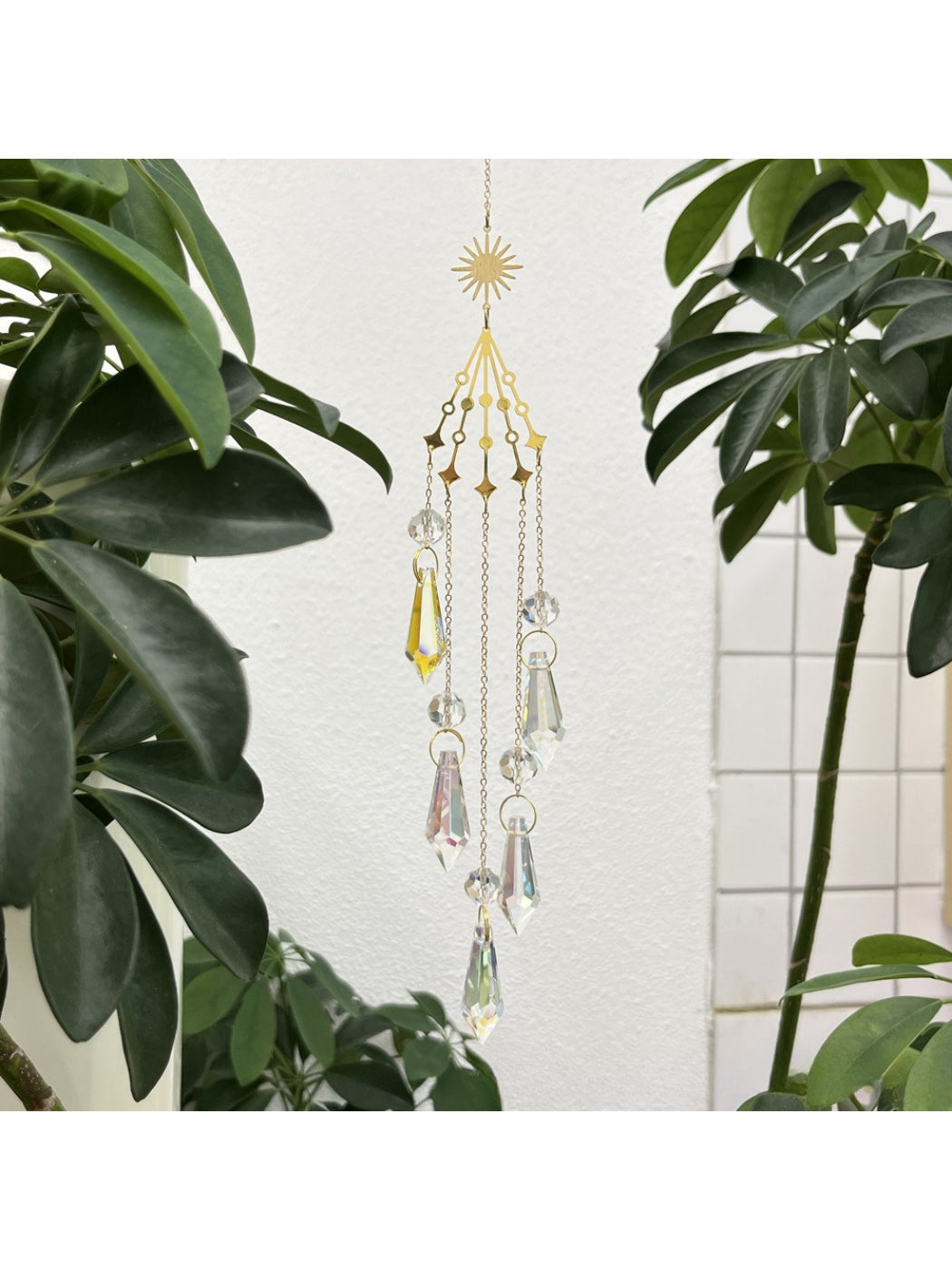 Somnia Star Moon Rainbow Sun Catcher illuminated by sunlight creating prism colors