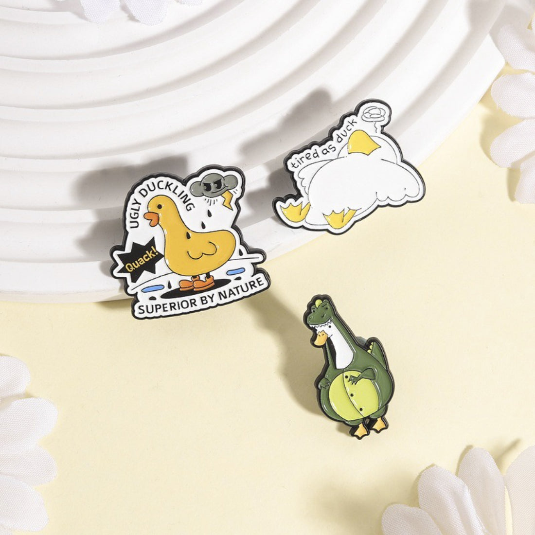 Pinori enamel pin attached to denim fabric highlighting its size and design
