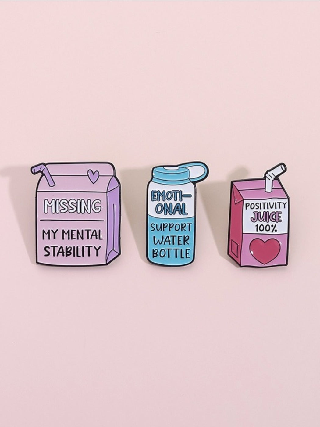 Close-up of Pinori juice bottle brooch highlighting colorful label and metal pin
