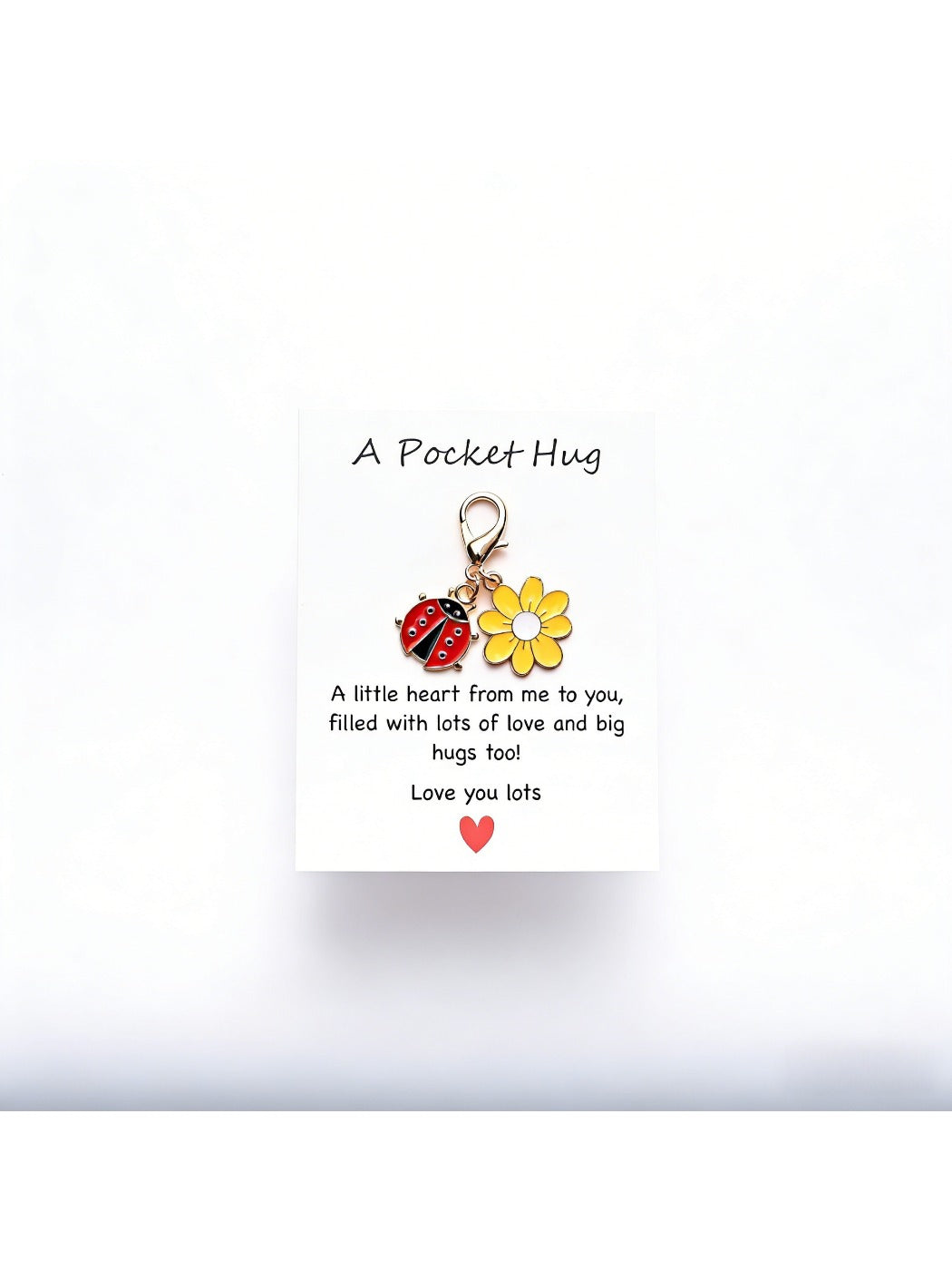 Taphug Pocket Hug Daisy Keychain displayed with daisy charm and gold ring on a textured background