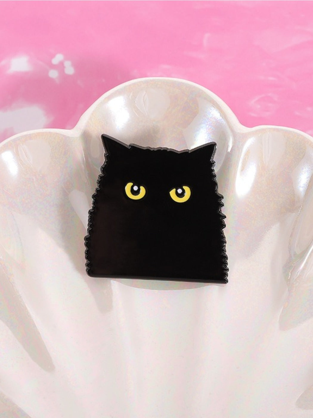 Pinori black cat shadow scary brooch displayed on a black fabric surface