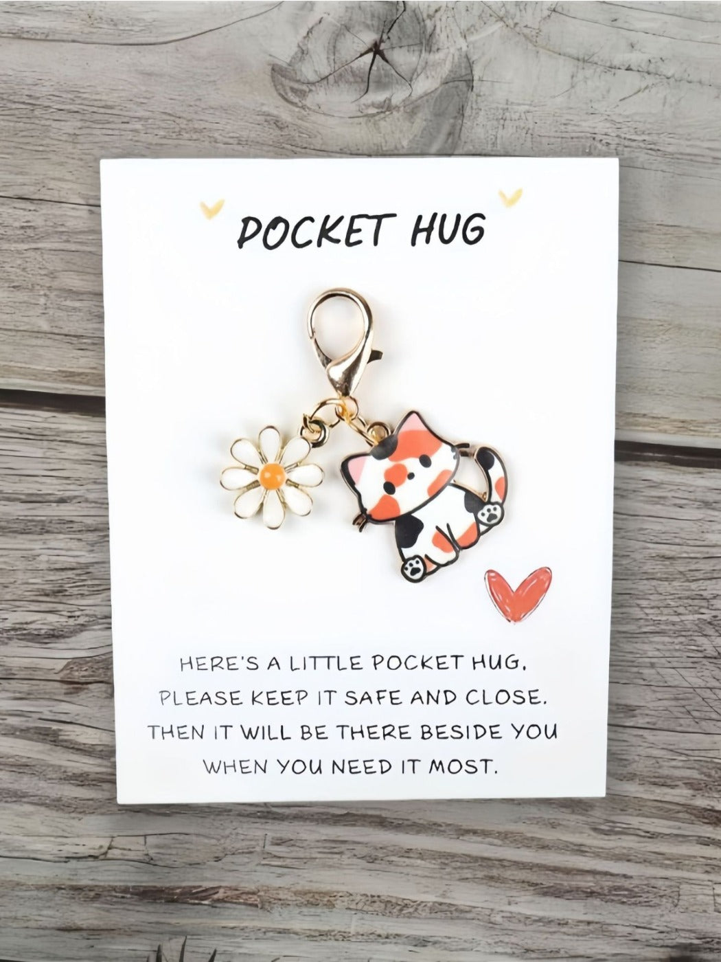 Taphug Pocket Hug keychain with cartoon cat charm photographed with soft lighting