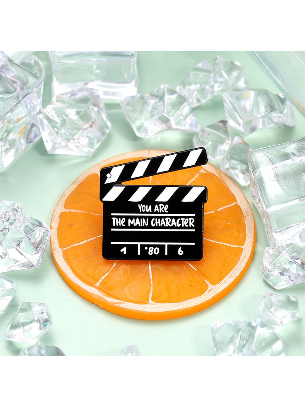 Close-up of Pinori clapperboard brooch showing detailed design