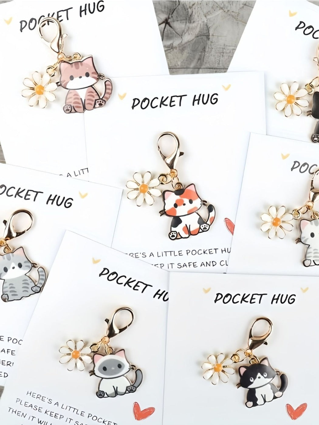 Close-up of Taphug Pocket Hug keychain with cartoon cat charm showing detailed design
