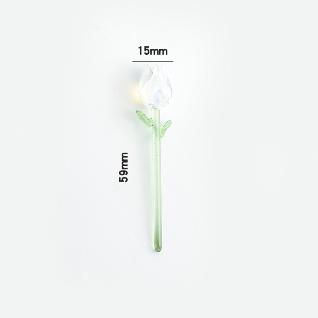 Side view of a small handcrafted glass rose showing detailed petals and leaves