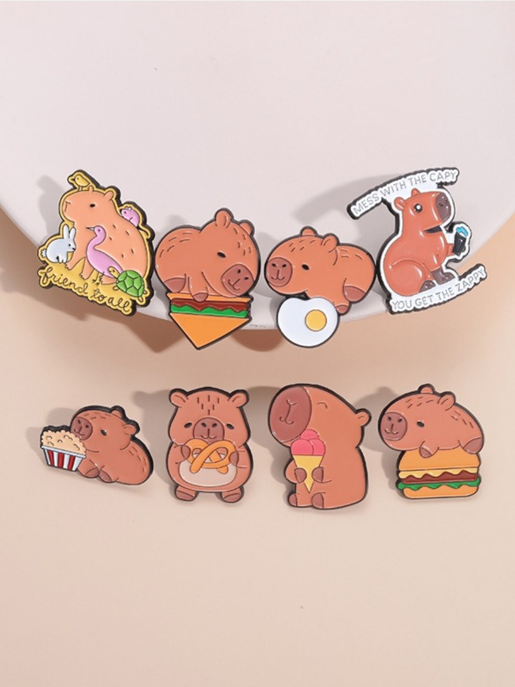 Pinori capybara animal brooch with hamburger design on metal pin, front view