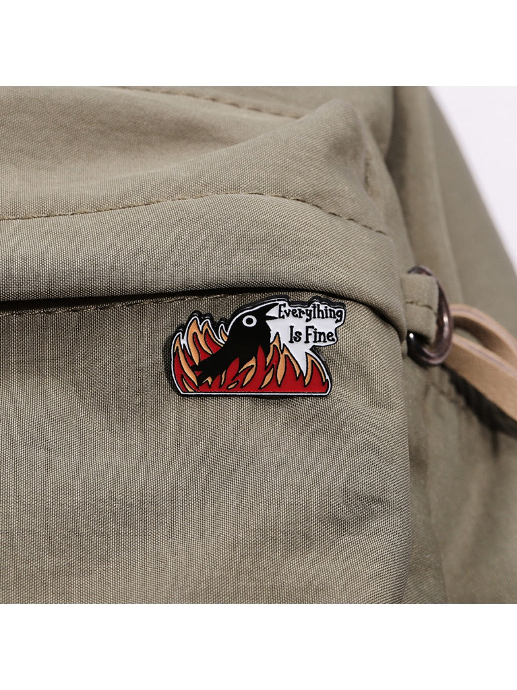 Pinori motivational brooch worn on a black jacket lapel