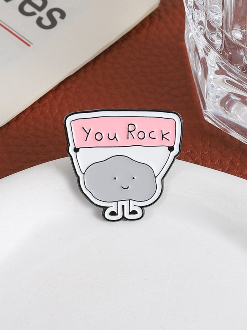 Close-up of Pinori YOU ROCK cloud badge showing detailed lettering and colors