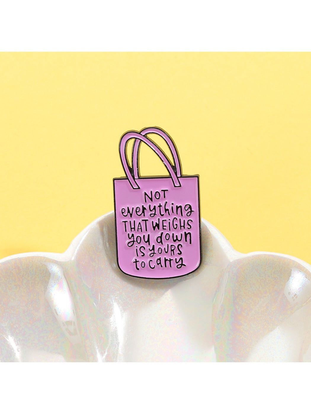 Side view of Pinori pink tote bag shaped brooch highlighting its thickness and clasp