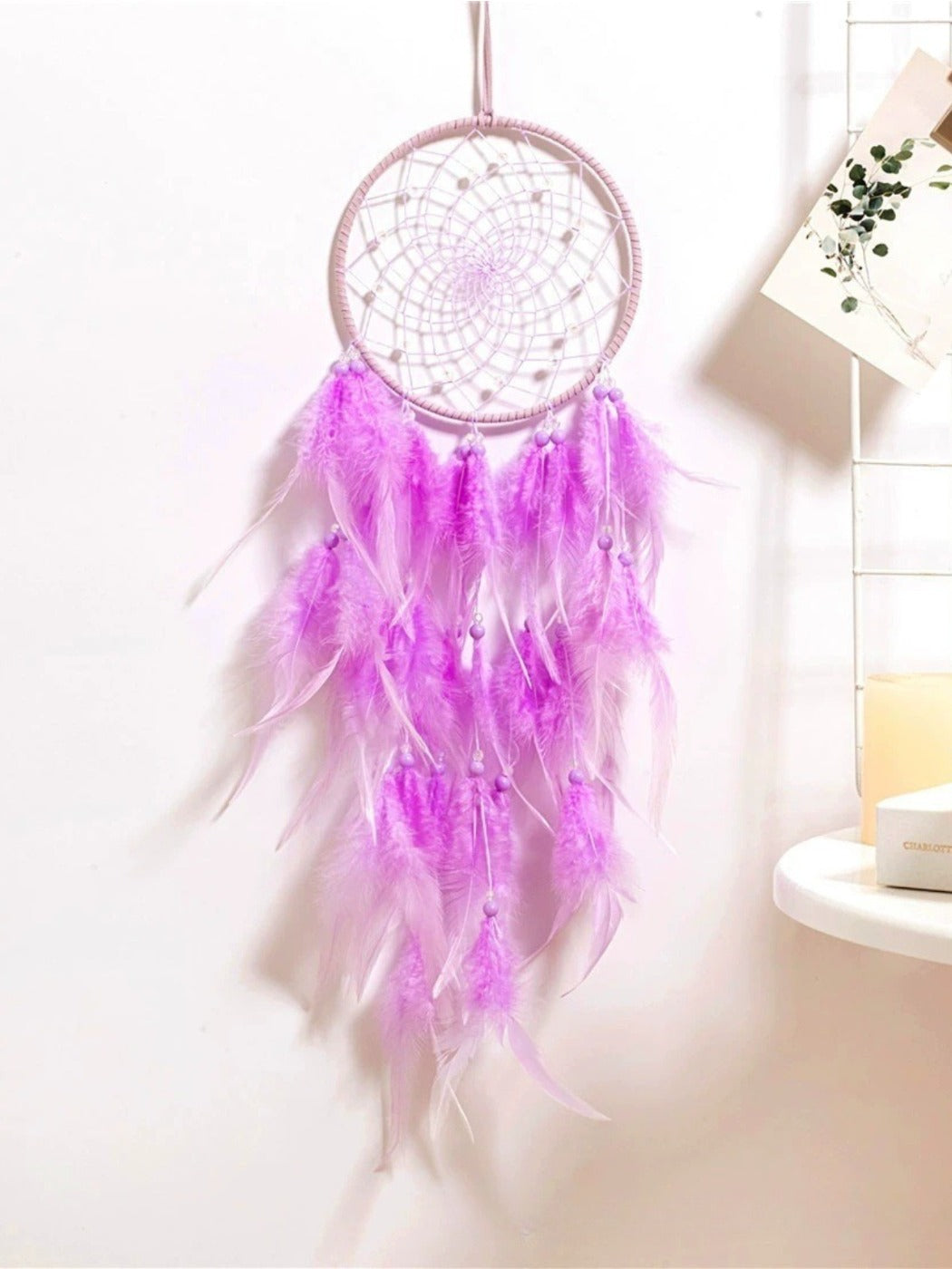 Full view of Somnira dreamcatcher wind chime showing circular web and hanging chimes