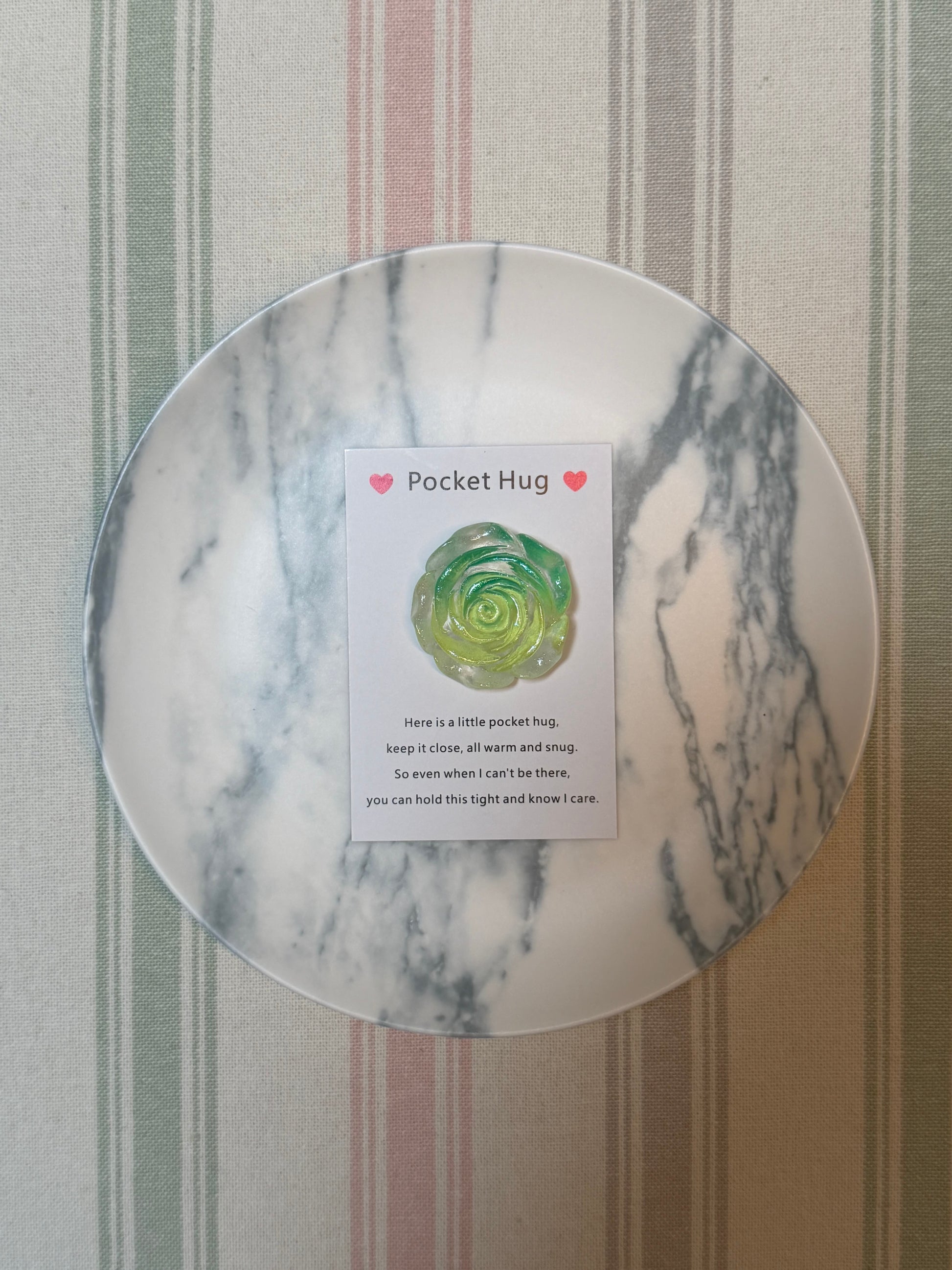 Card and glow-in-the-dark rose token displayed together
