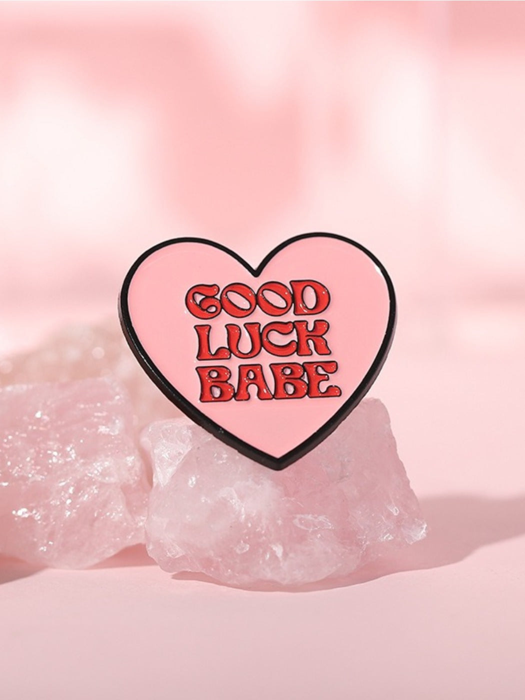 Close-up of Pinori stylish wind color letter love heart pin on white background