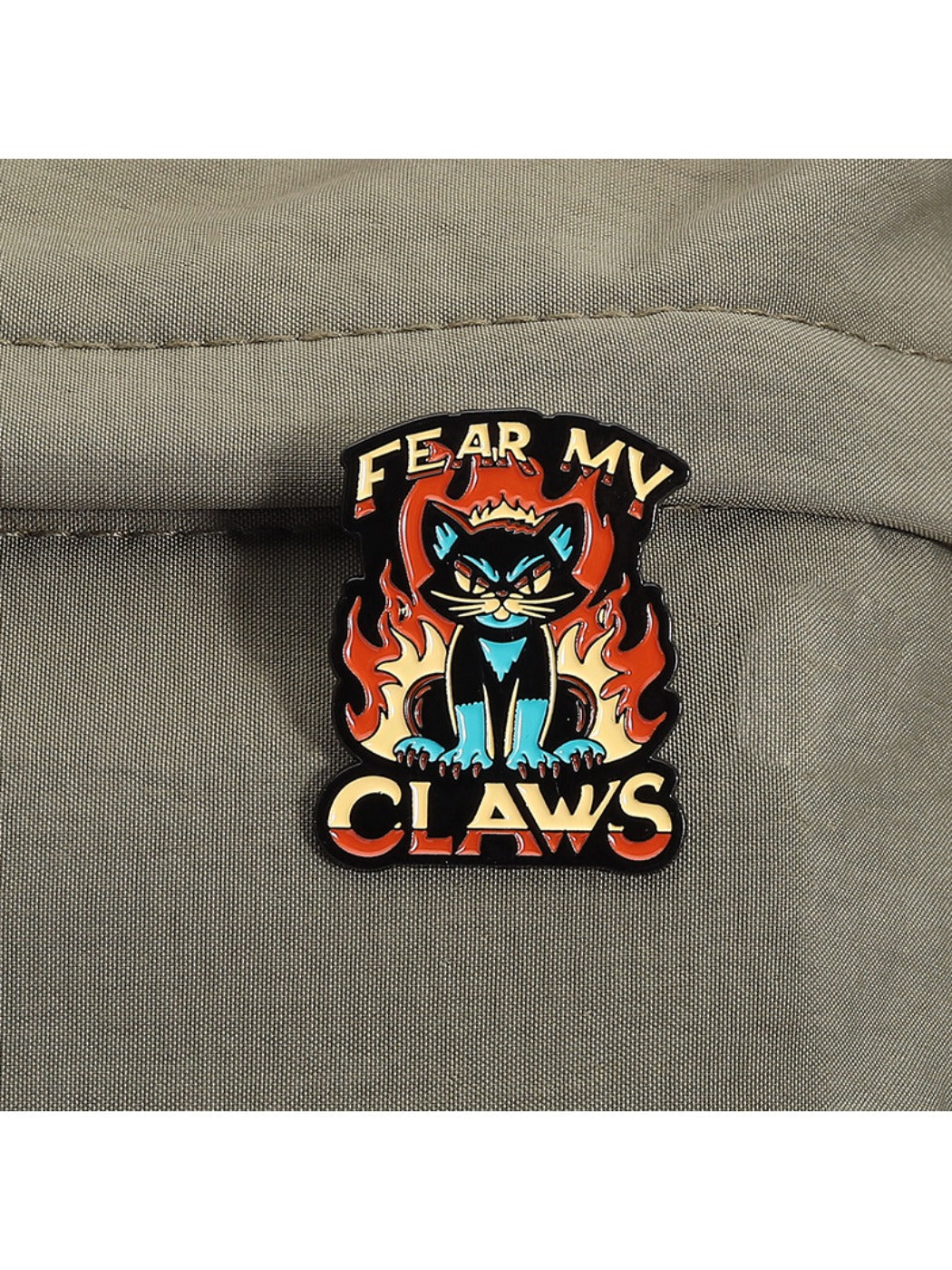 Detailed shot of angry tiger skull with flame cat motifs on Pinori brooch