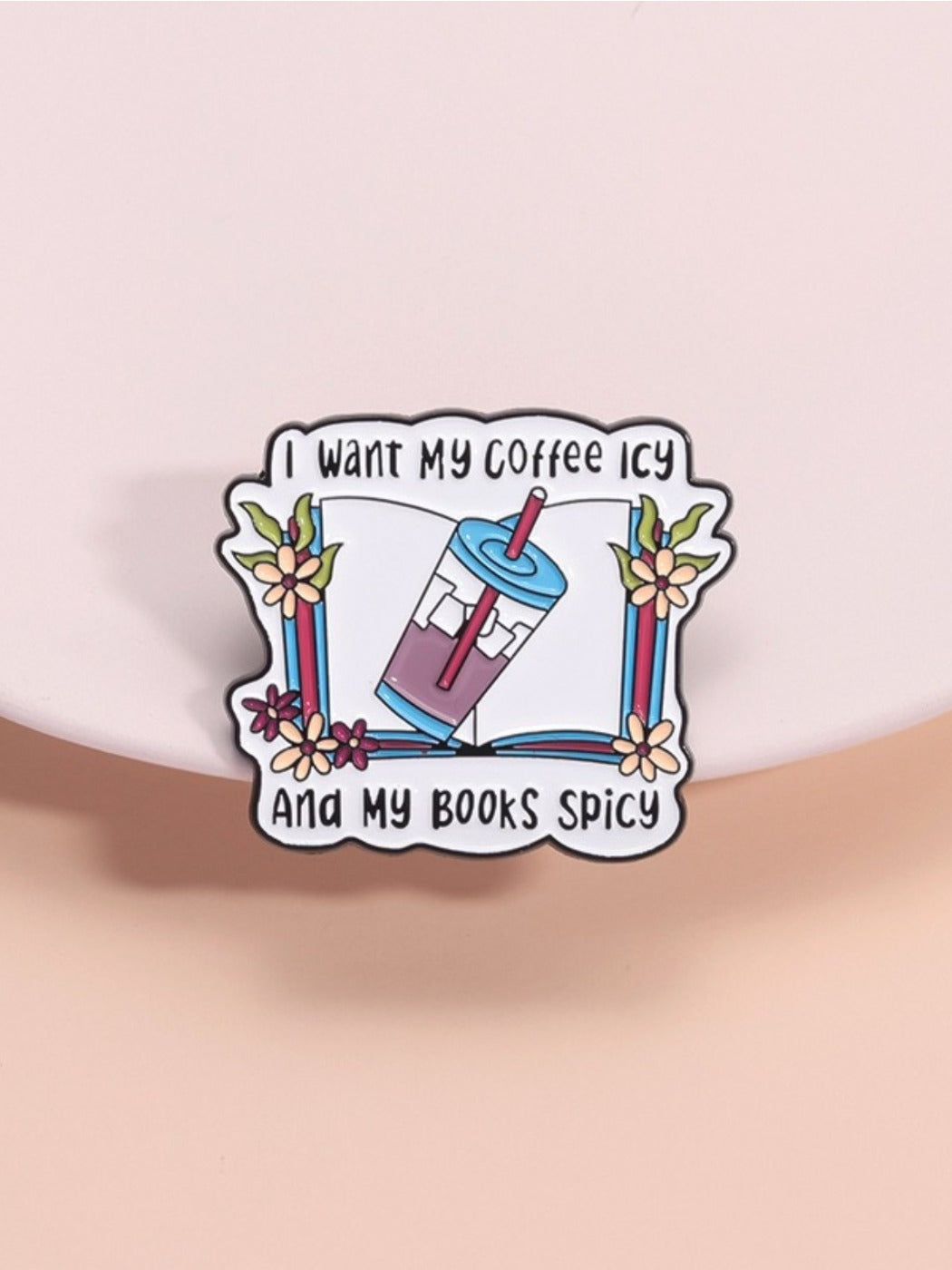 Pinori vintage book pin with 'I Want My Iced Coffee' text on a wooden surface