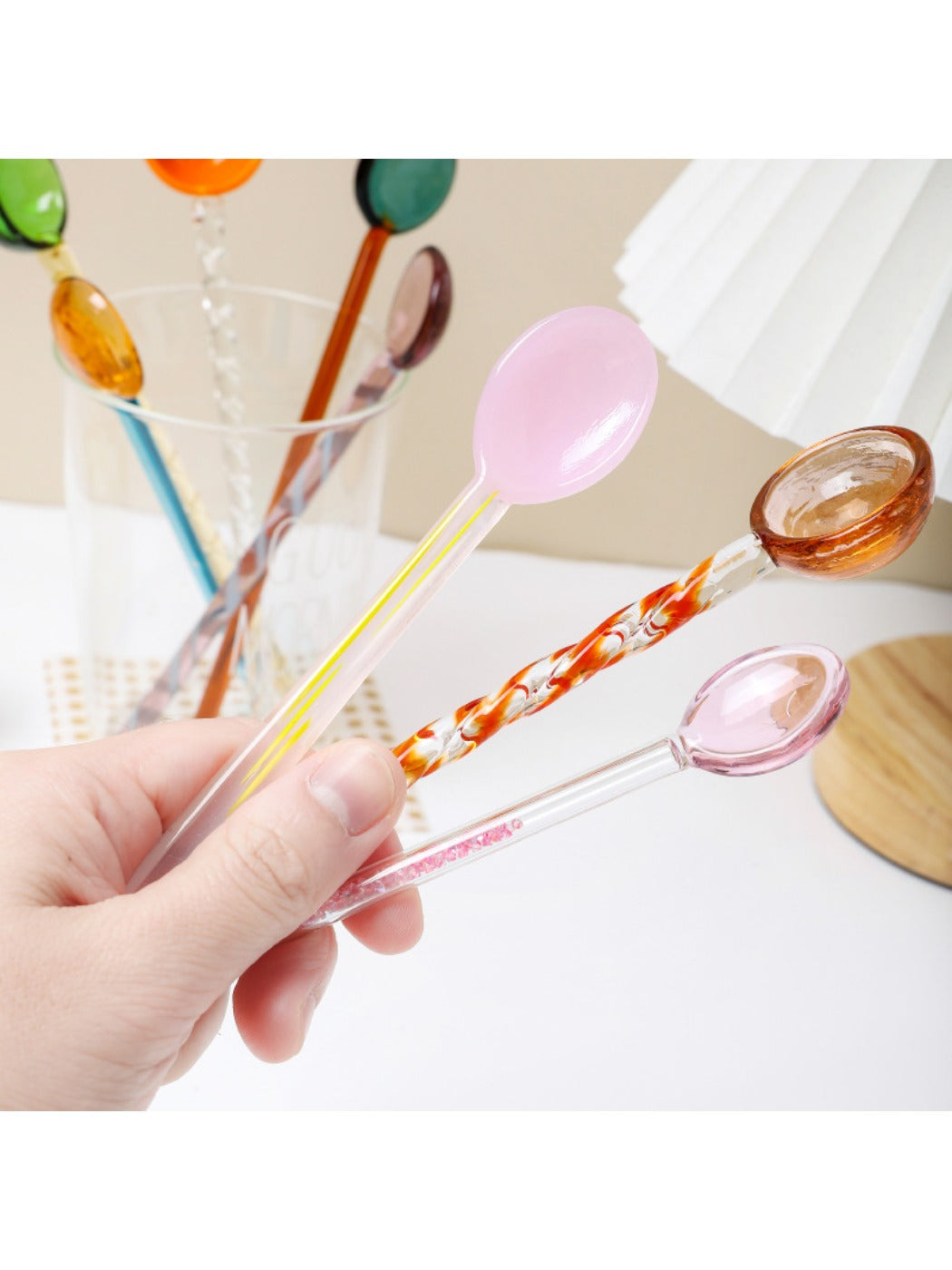 Thimara long handle glass spoon placed diagonally on surface