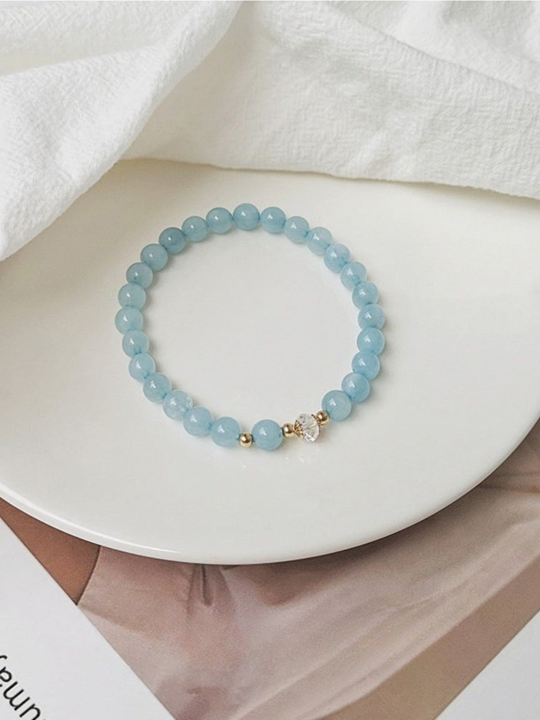 Emora white crystal bracelet worn on a hand, highlighting its sparkle and design