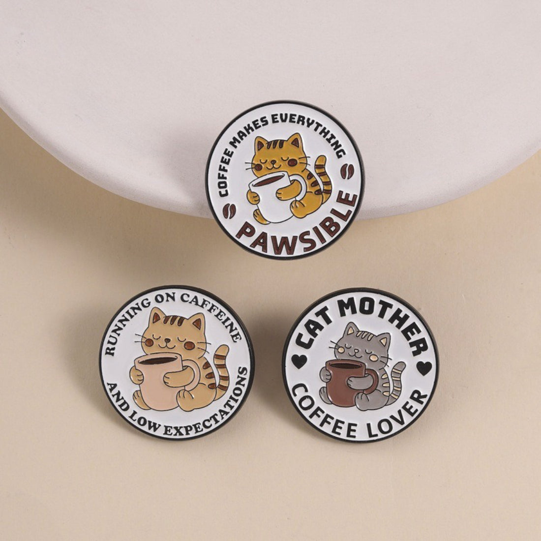 Pinori Pawsible Coffee Cat enamel pin showing a cat holding a coffee cup