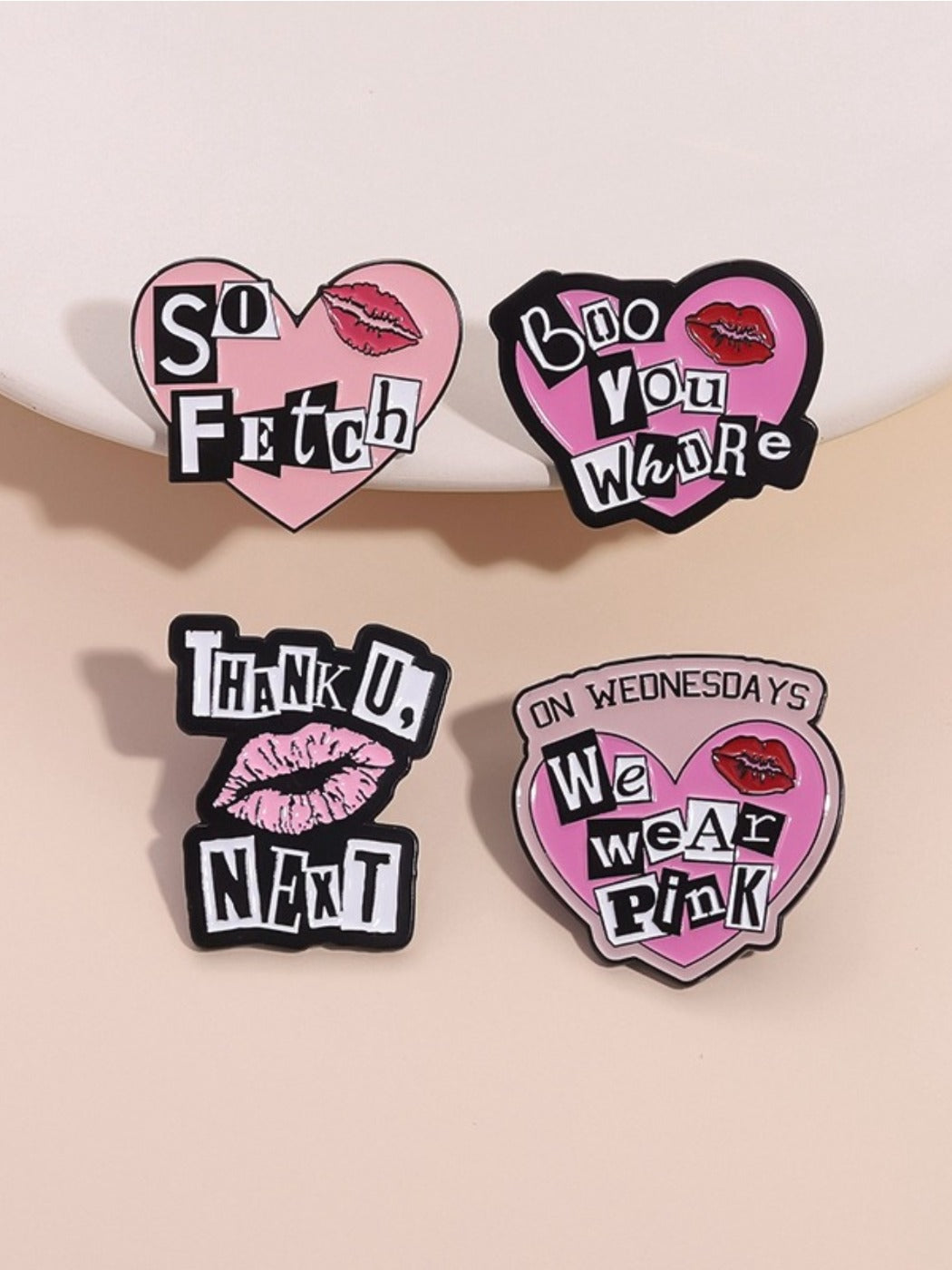 Close-up of Pinori punk style pink heart alphabet metal pin on black fabric