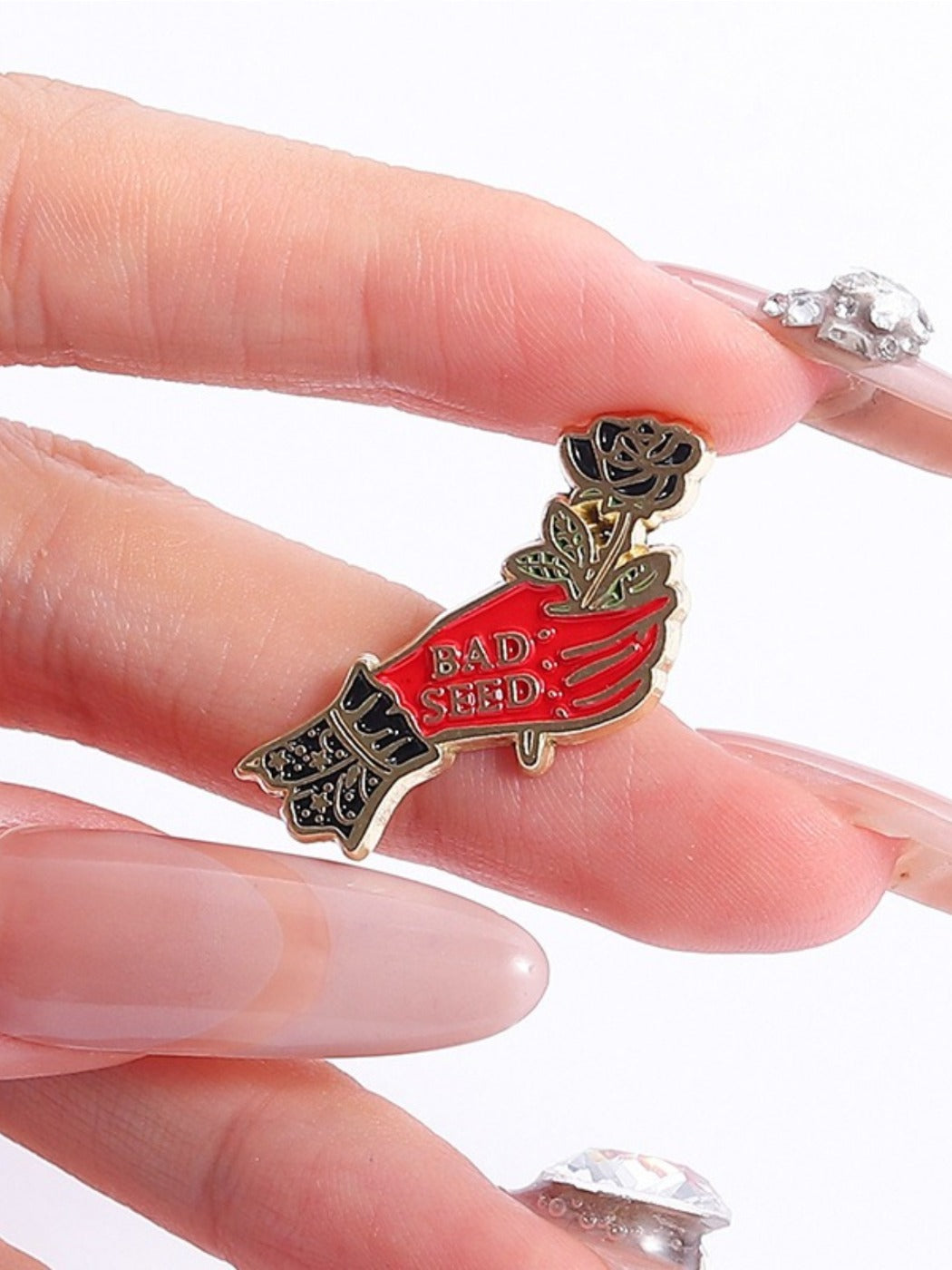 Pinori black rose brooch worn on a dark jacket lapel