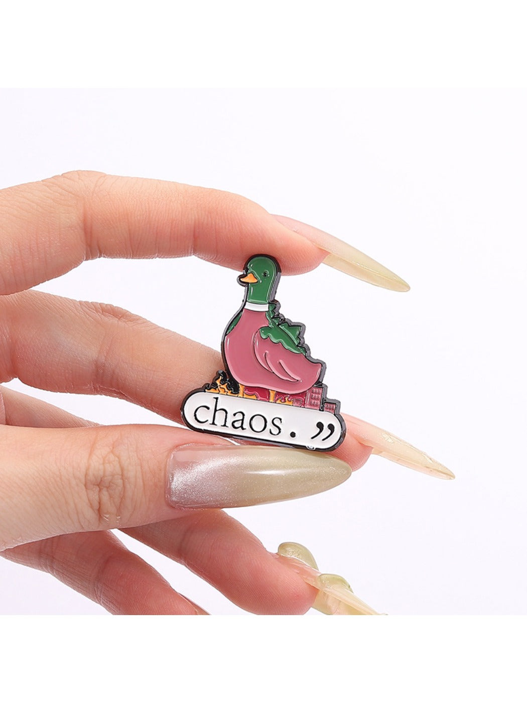 Pinori green duck brooch displayed on a black fabric surface