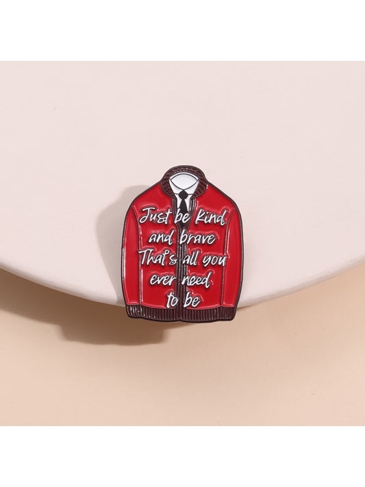 Close-up of Pinori red fashion pin with inspirational text on white background