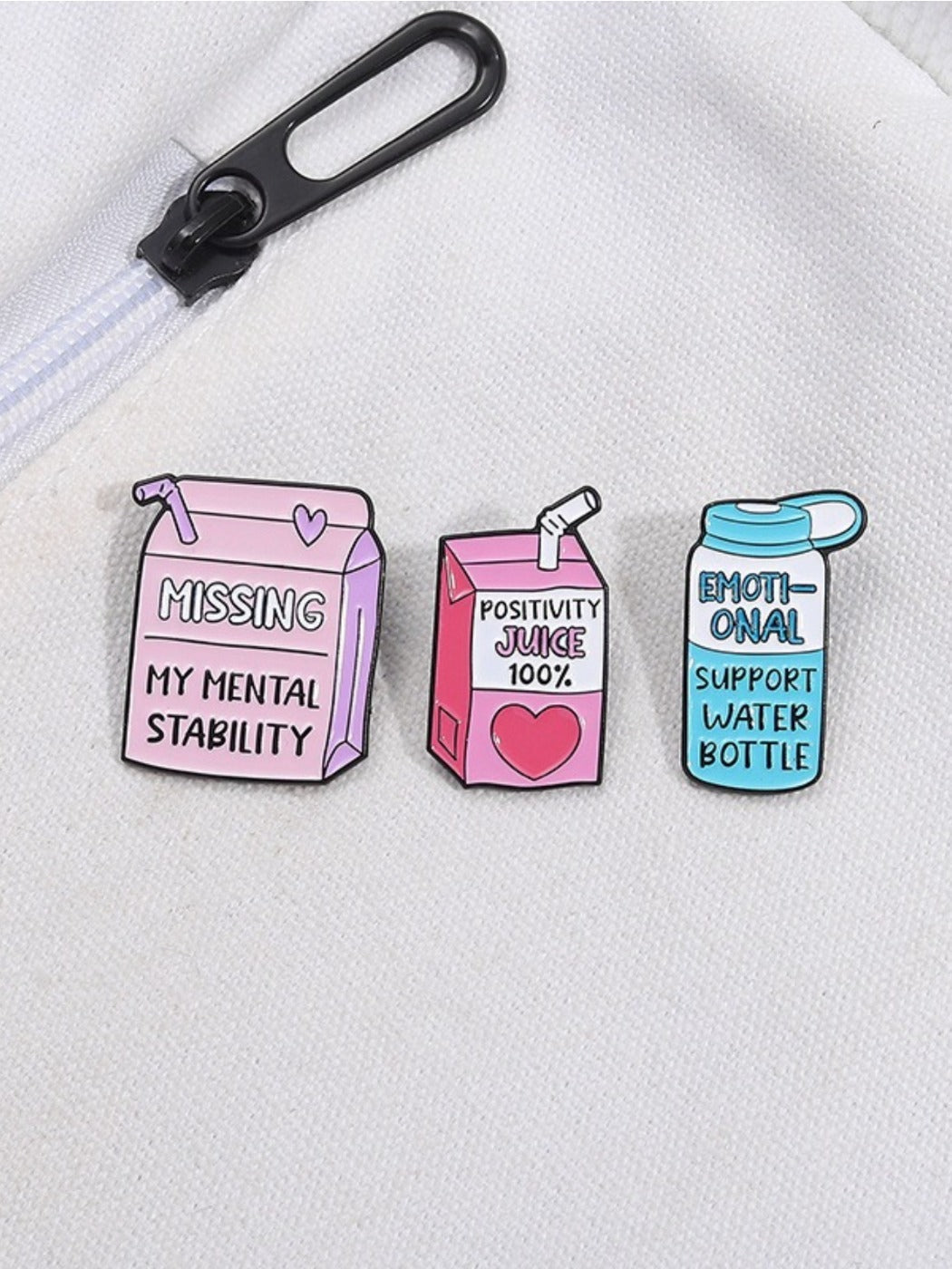 Side view of Pinori motivational juice bottle brooch displaying thickness and clasp