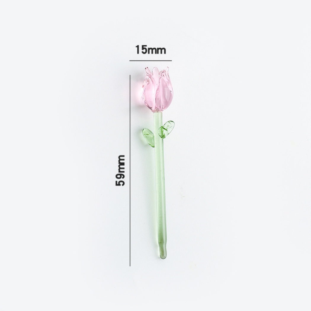 Close-up of the green glass leaves attached to the pink glass rose stem