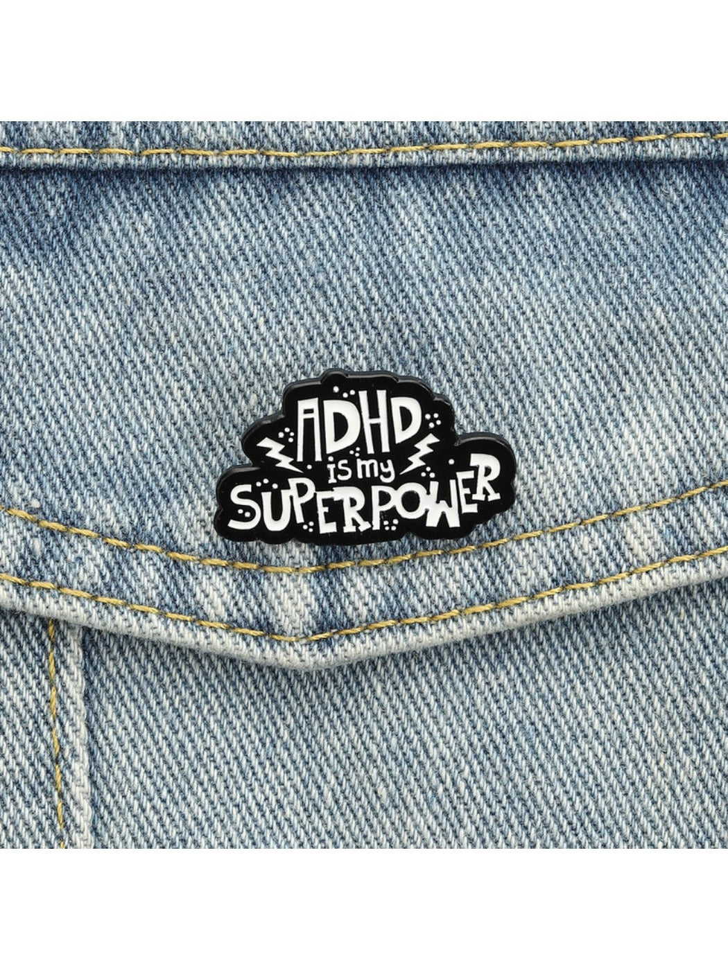 Pinori pin badge attached to a backpack strap with visible text and vibrant colors