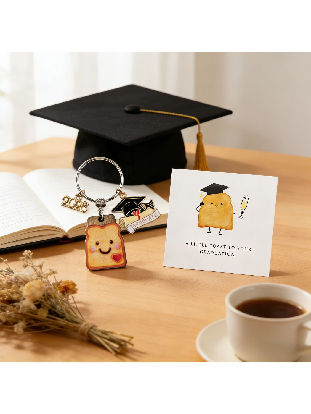 Taphug graduation keychain with resin bread cookie charm hanging from gold ring