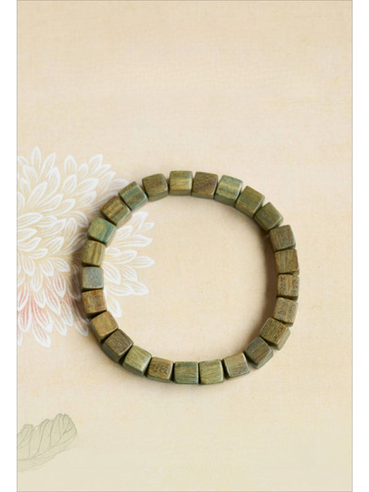 Close-up of Emora square green beaded bracelet on white background