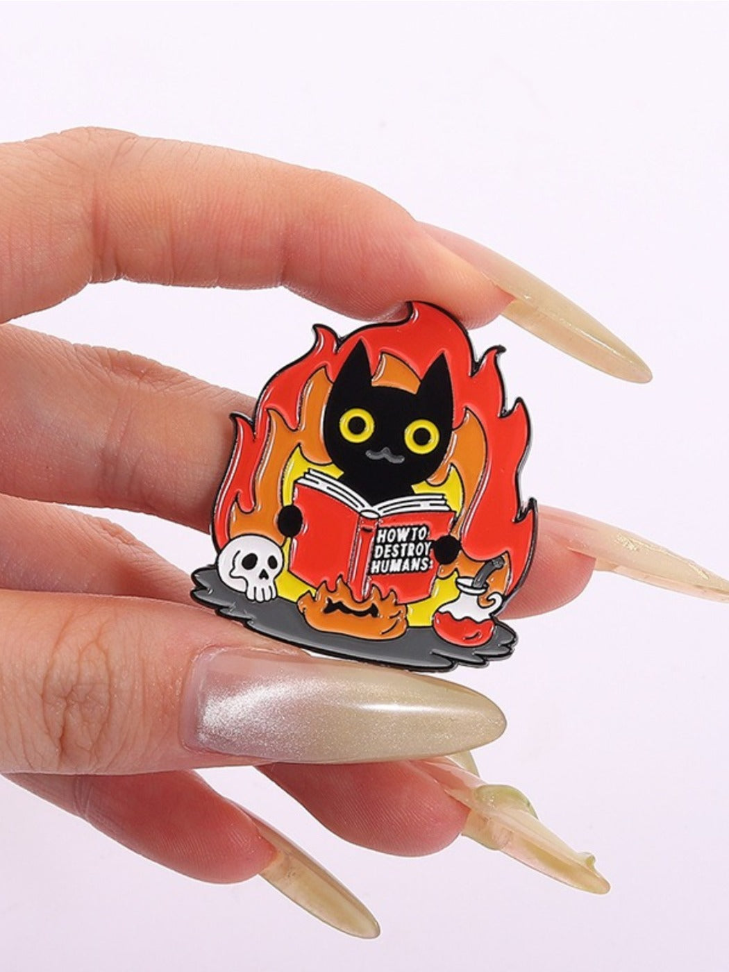 Pinori black cat flame badge shown with other colorful enamel pins