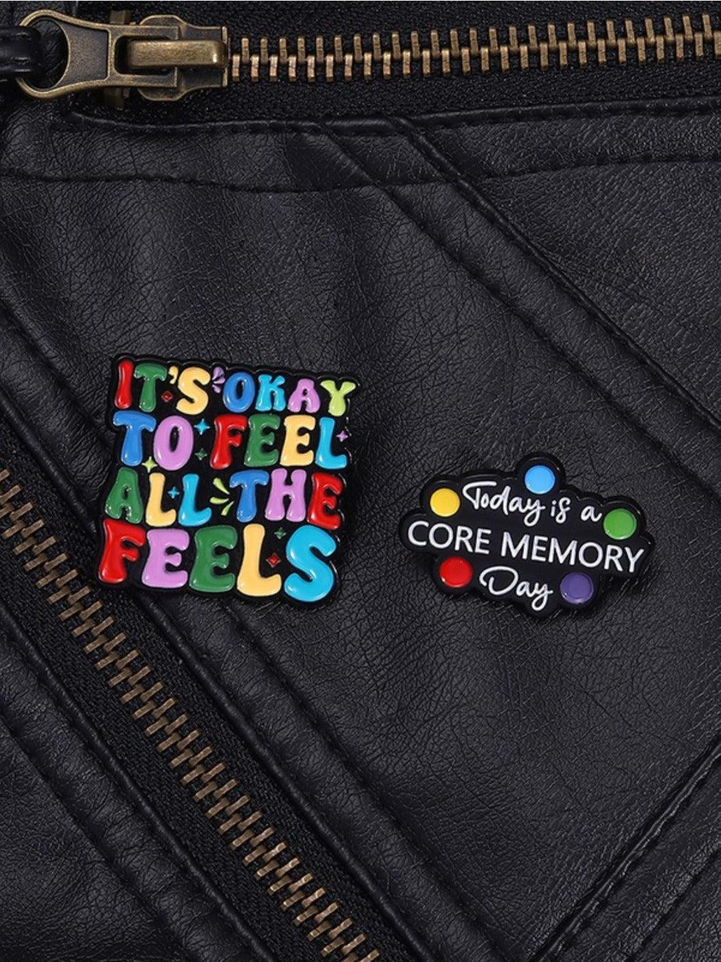Pinori brooch displayed on fabric, highlighting colorful English sentence