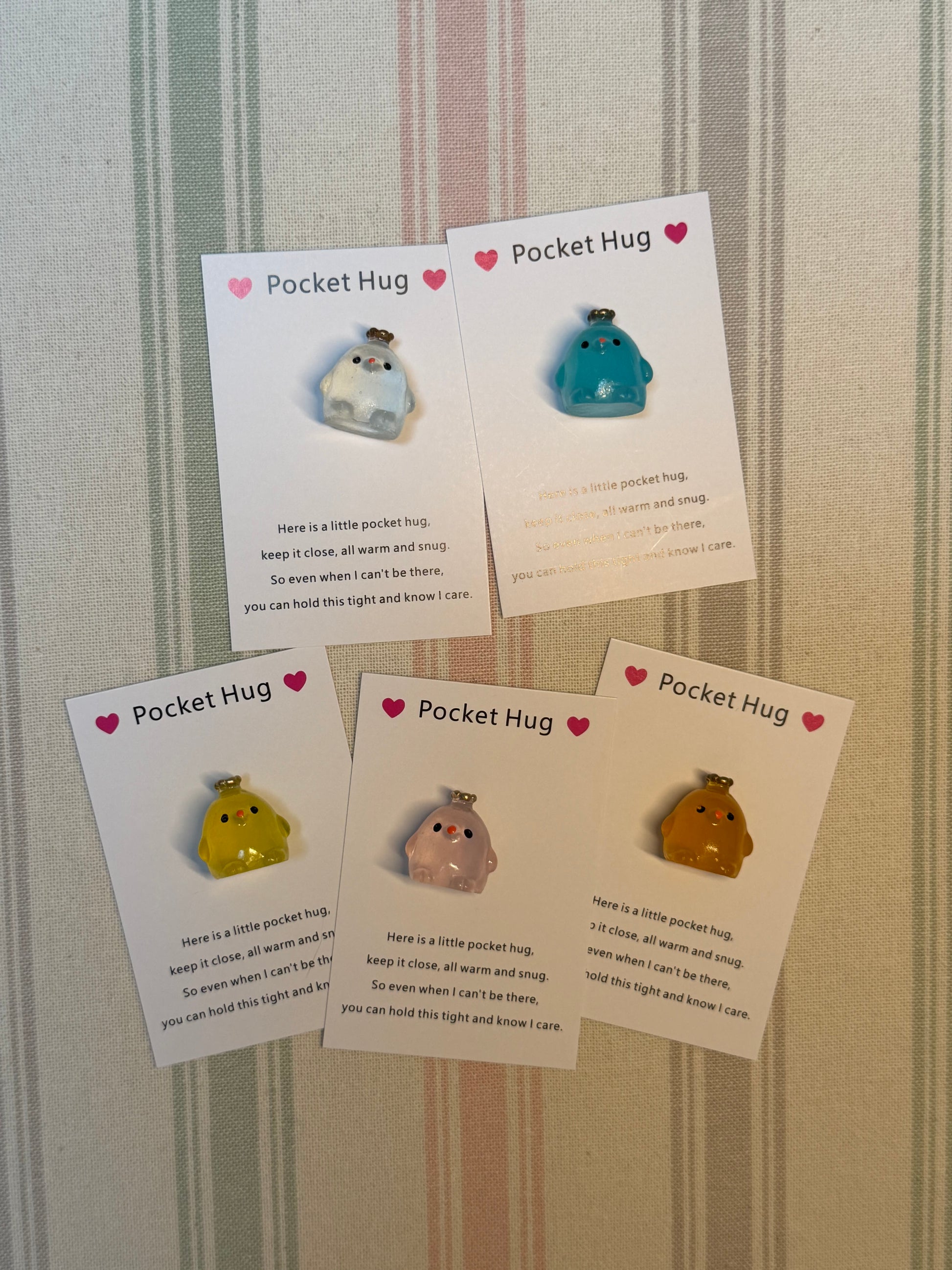 Taphug pocket hug card with crown chick illustration and glow-in-the-dark token beside it