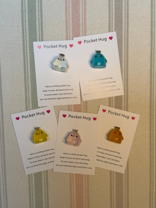 Taphug pocket hug card with crown chick illustration and glow-in-the-dark token beside it