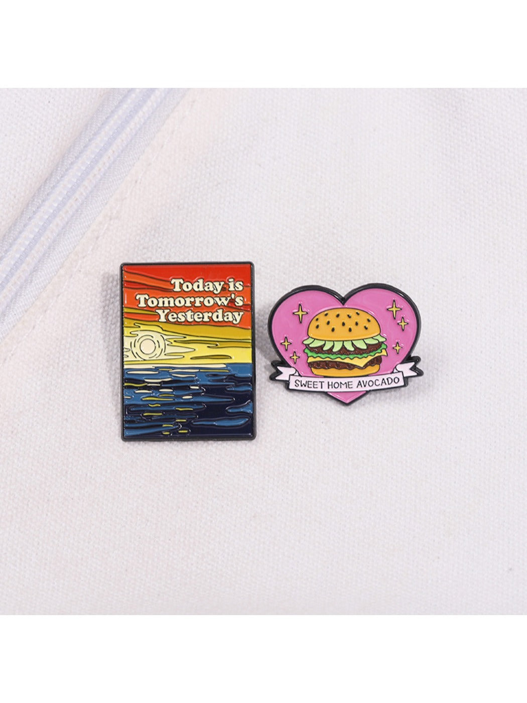 Pinori hamburger lapel pin displayed on a black fabric background
