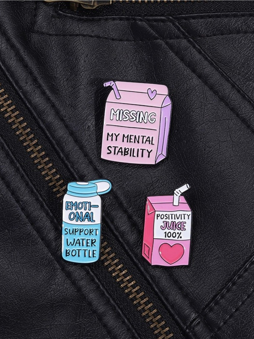 Pinori motivational juice bottle brooch worn on lapel of black blazer