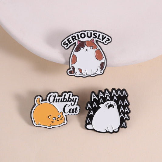 Pinori chubby cat mood enamel pin with a smiling orange cat on white backing card