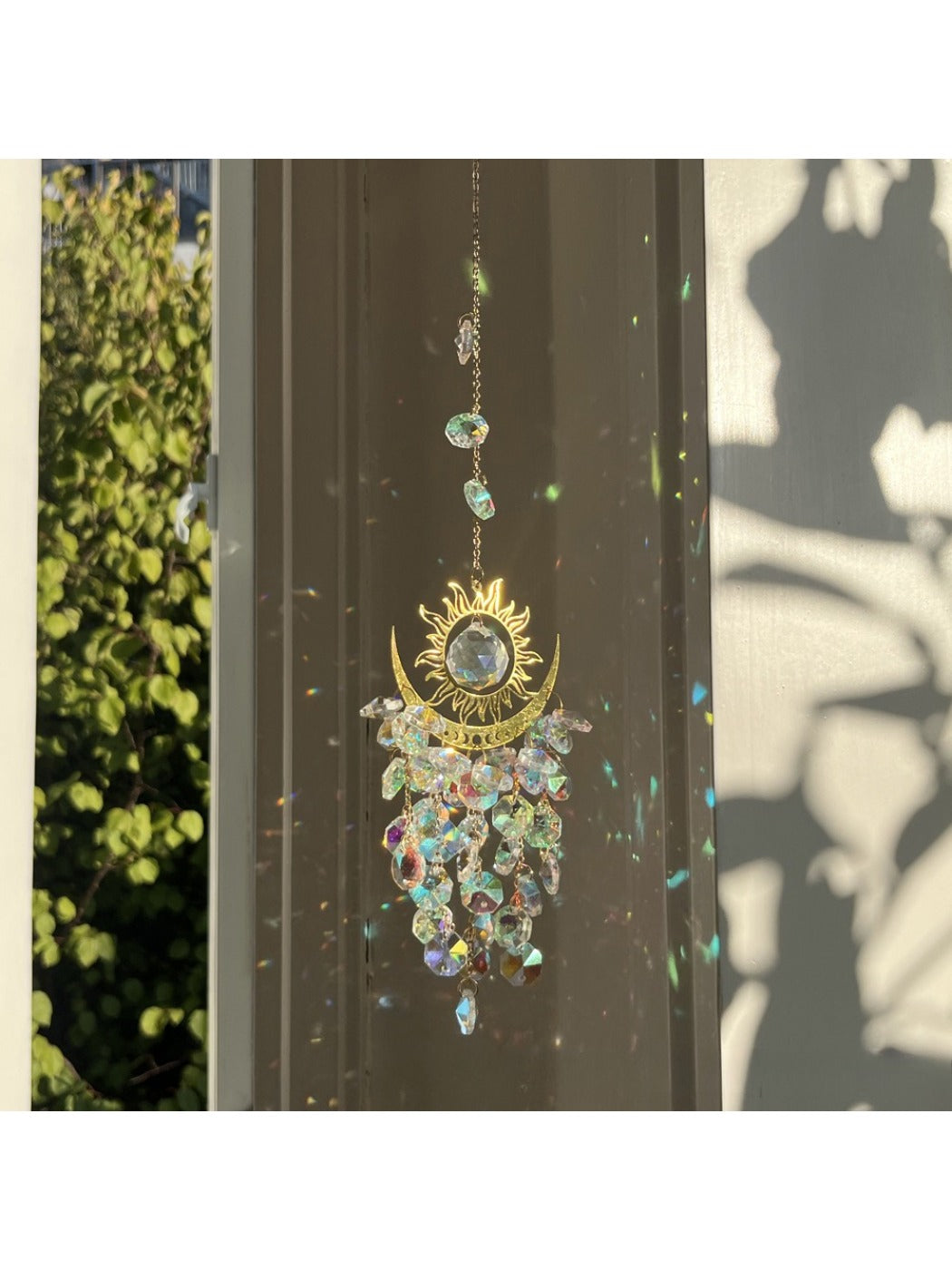 Somnira Sparkle Evil Eye Dream Catcher hanging on a white wall with blue and silver beads