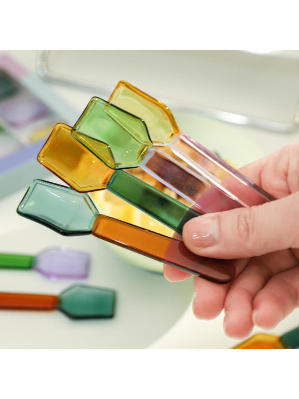 Thimara colorful glass spoon placed on a wooden surface highlighting its dessert theme