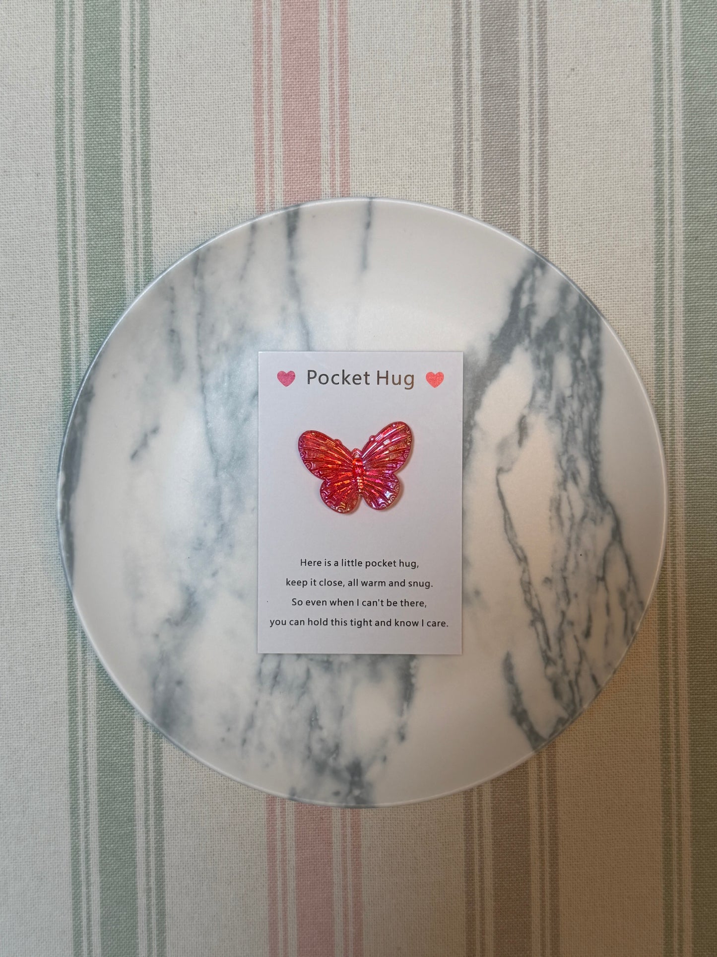 Single pocket hug card with butterfly illustration beside its lightweight token