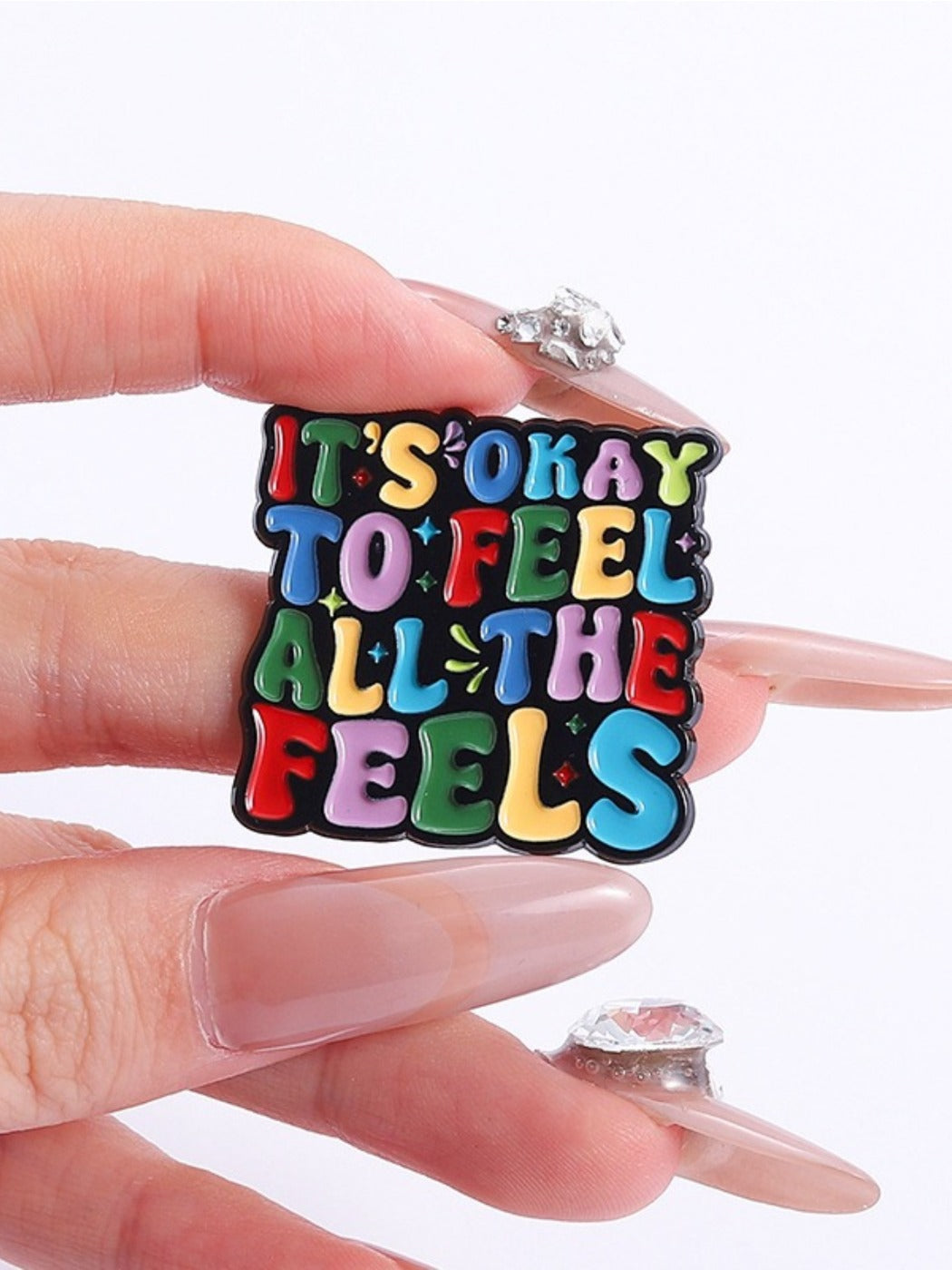 Side view of colorful English sentence lapel pin with metal backing