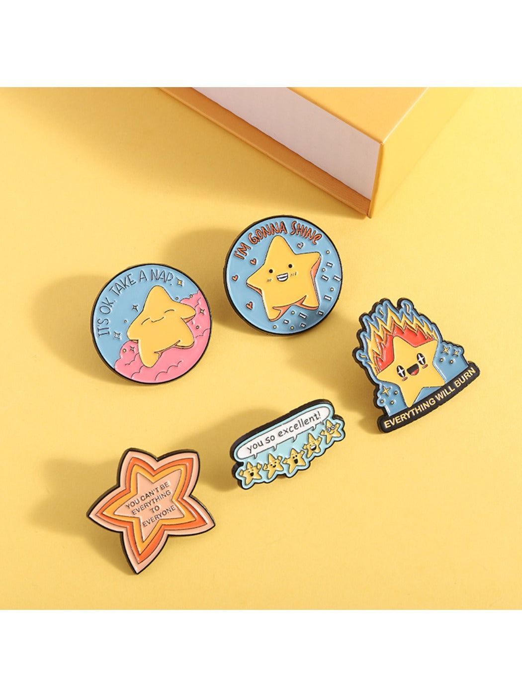 Pinori cartoon star pin displayed on a black fabric surface
