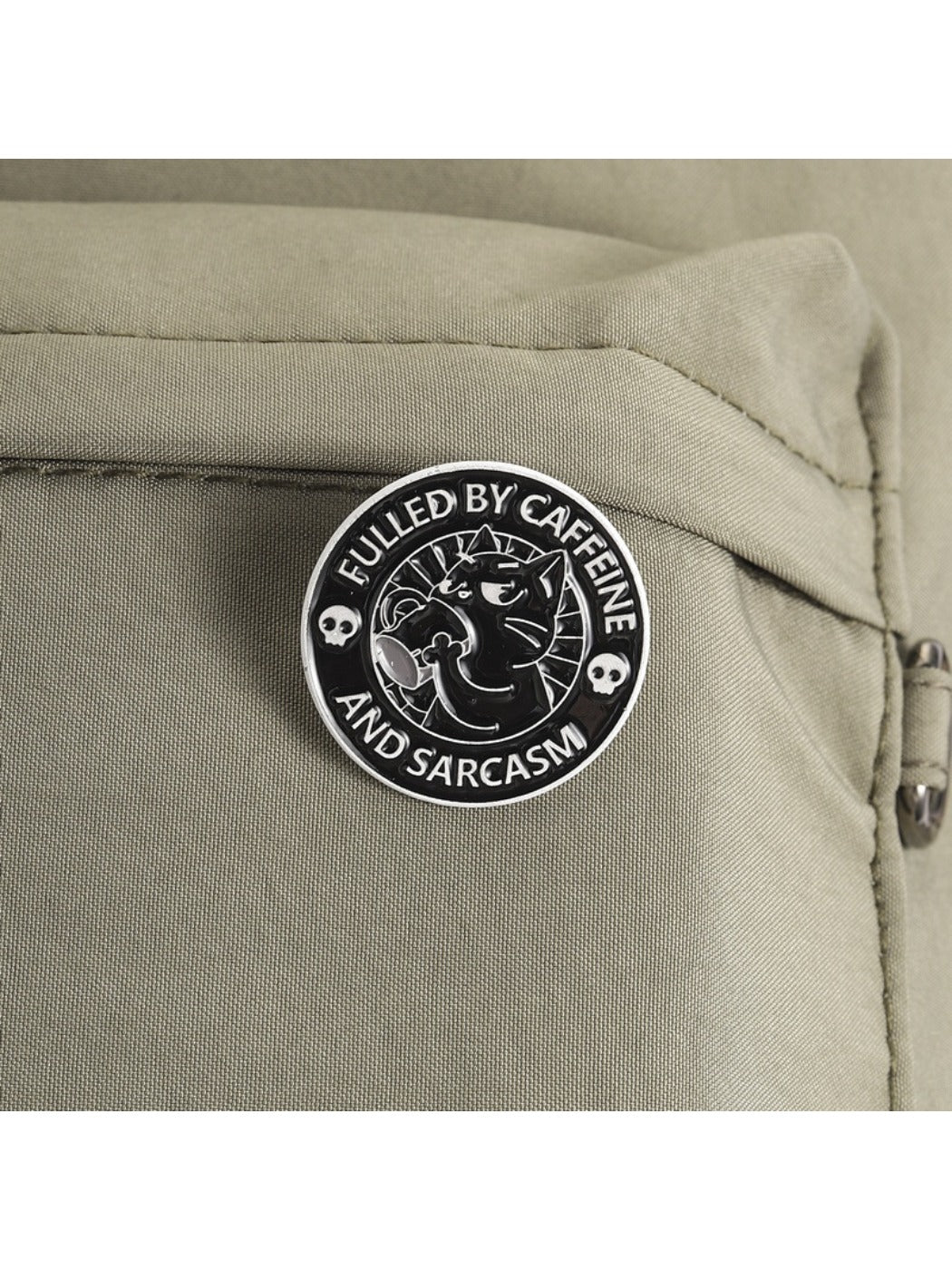 Close-up of Pinori black coffee cat brooch showing detailed enamel finish