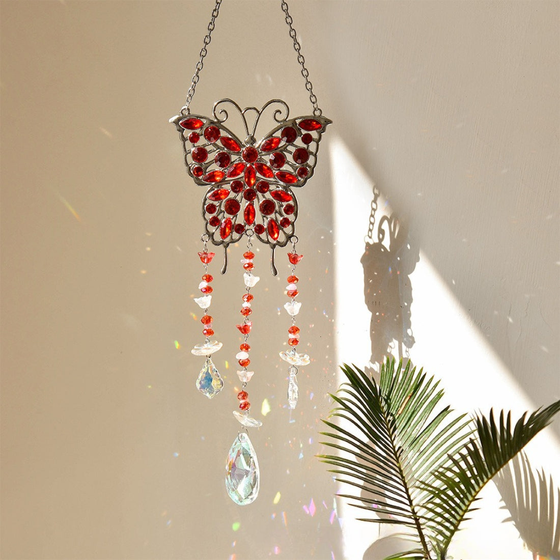 Somnira butterfly suncatcher casting colorful light reflections on a surface