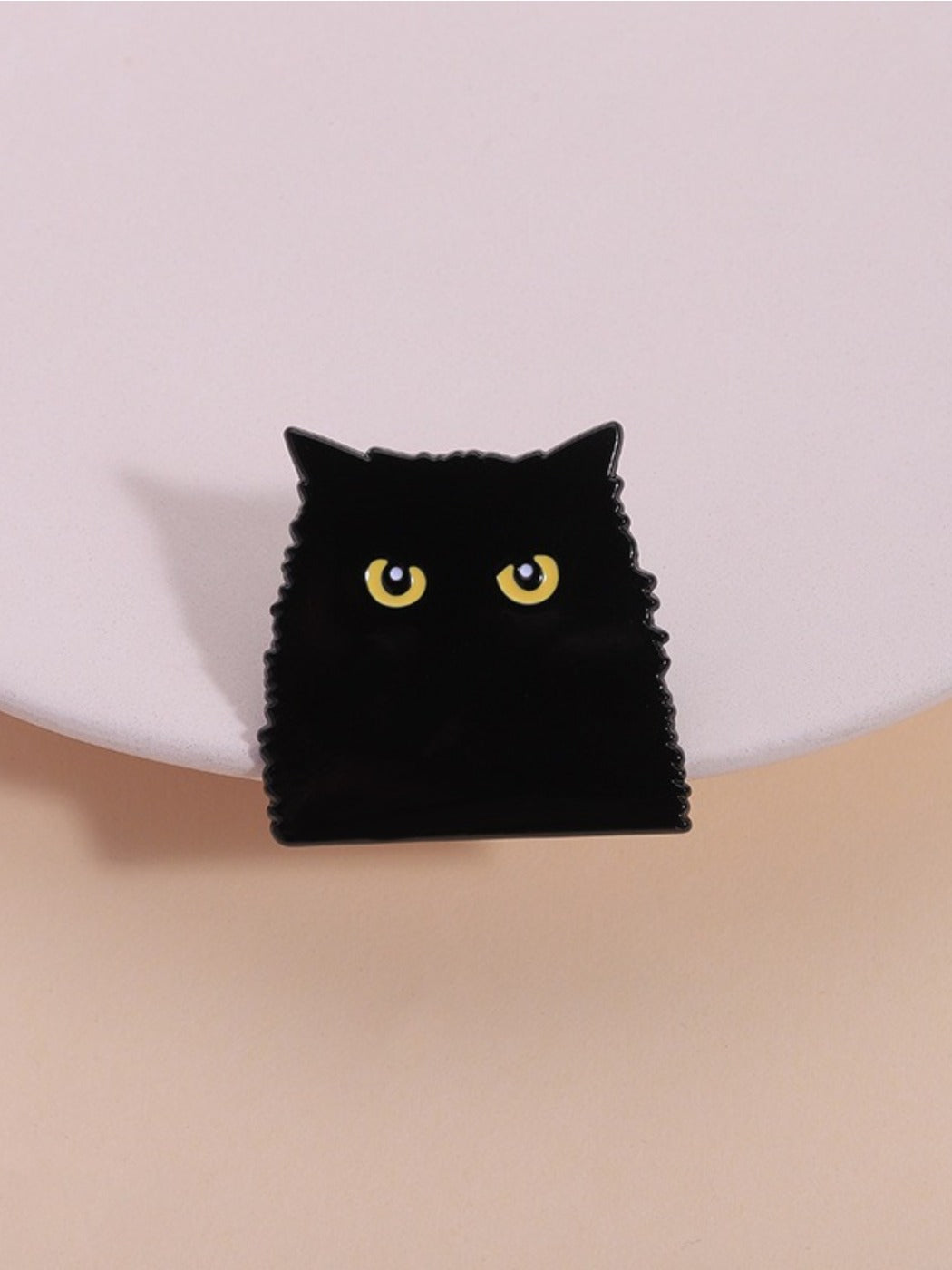 Close-up of Pinori gothic black cat shadow metal brooch on white background
